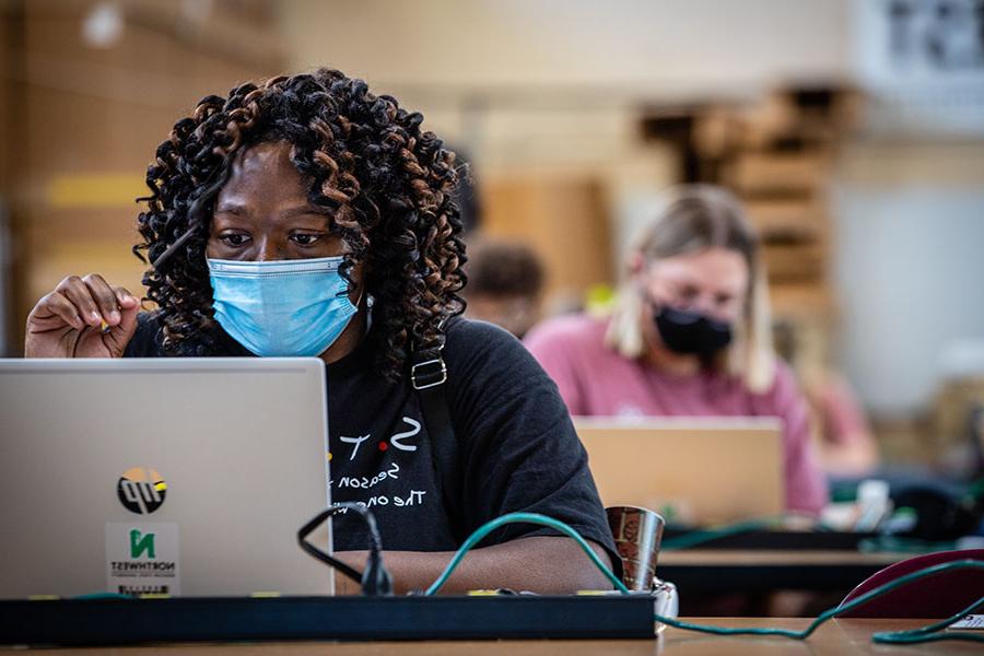 Above, students set up their new Northwest laptops as the campus opened in August for the 2020-21 academic year. The University's long-standing laptop rental program helps students save on tuition costs compared to their peers at other universities and it has provided them with an advantage during the COVID-19 pandemic. (Photos by Todd Weddle/Northwest Missouri State University)